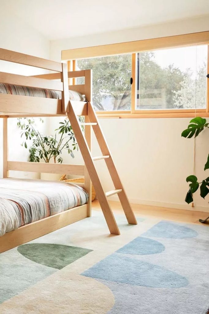 neutral rugs with green and blue geometric shapes