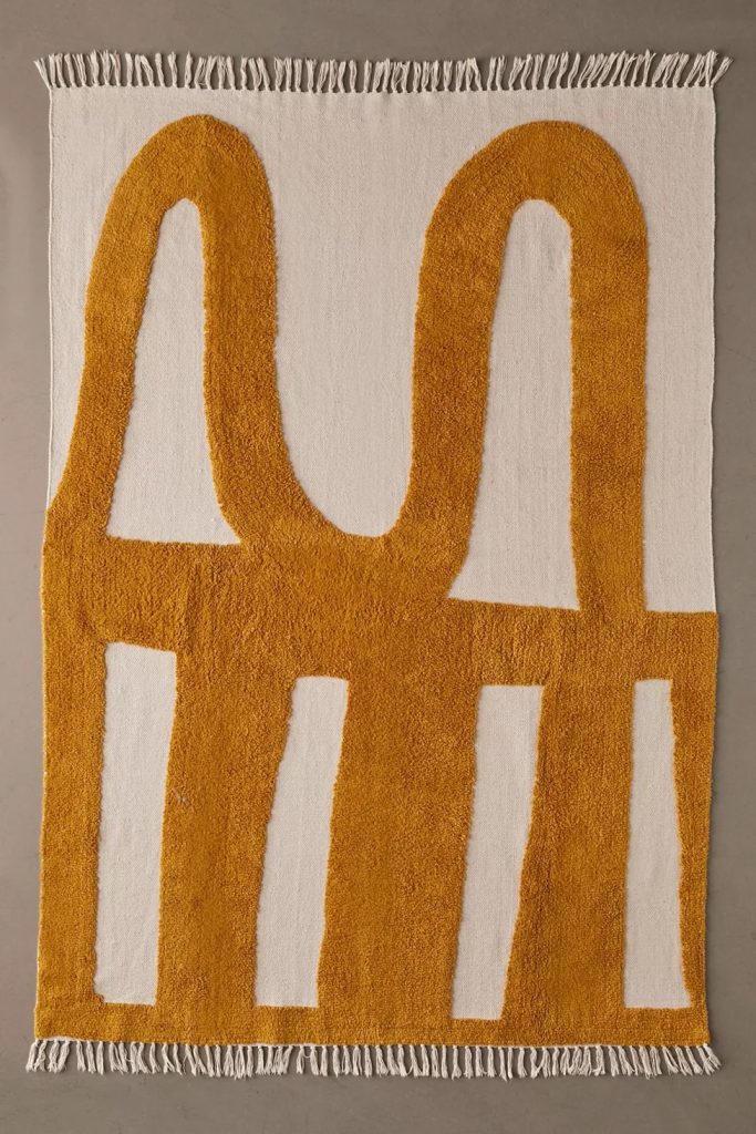 unique neutral area rug with wavy high-low mustard colored pattern