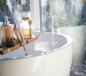 image of tub with bath tray. bathroom storage ideas post